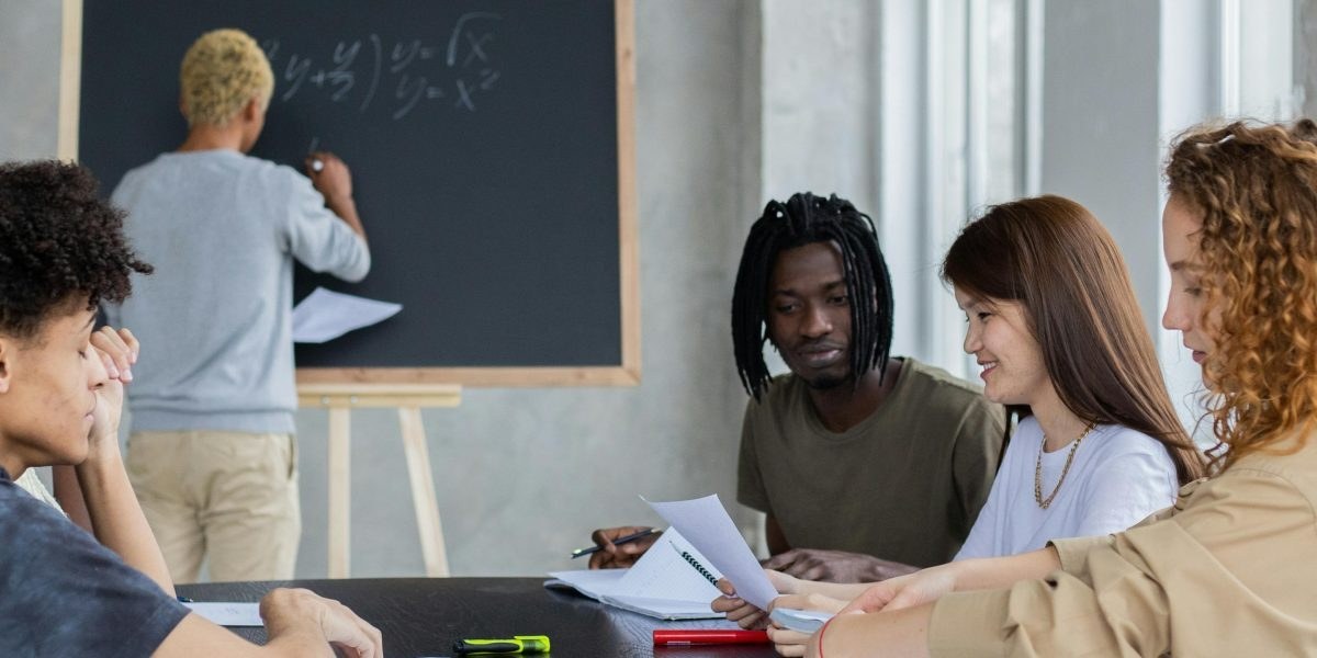Learners discussing ideas around a table