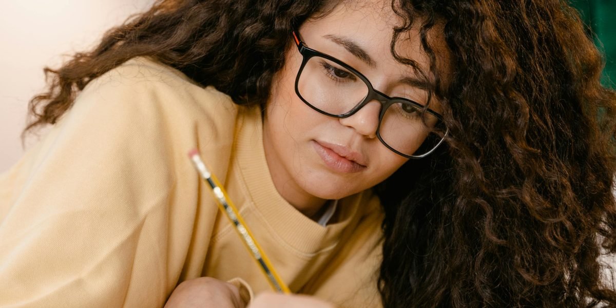 Embracing the flexibility of online education, a student focuses on their studies from a comfortable home environment.