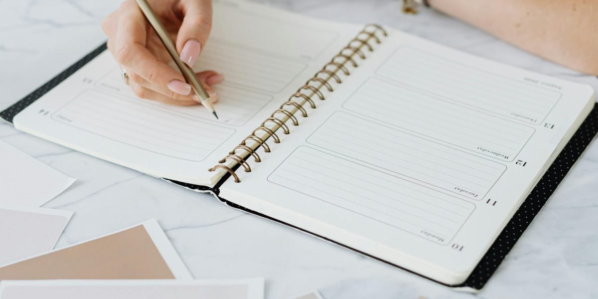 A person efficiently organizes their schedule, symbolizing effective time management crucial for balancing studies and life commitments.