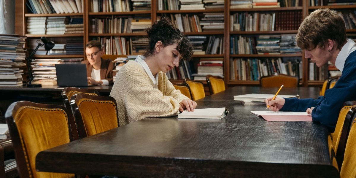 A person deeply concentrated on their studies, illustrating the self-directed nature of online learning and critical thinking.